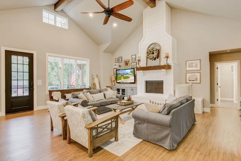 Design ideas for a country open concept living room in Dallas with a standard fireplace, a brick fireplace surround and vaulted.