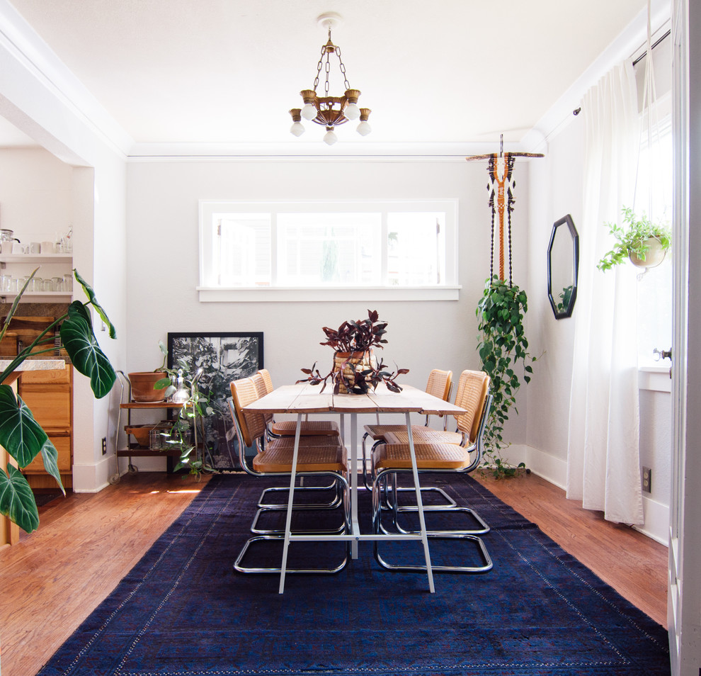 Design ideas for a mid-sized eclectic dining room in Portland with medium hardwood floors.