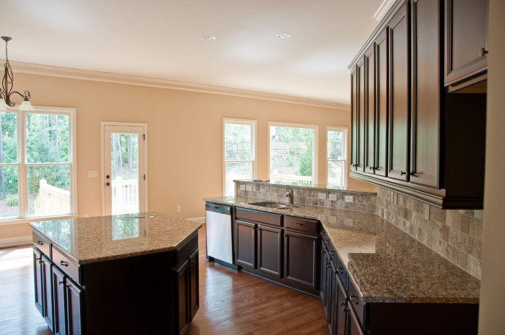 Kitchen - large dark wood floor kitchen idea in Minneapolis with an undermount sink, dark wood cabinets, multicolored backsplash, stainless steel appliances and an island