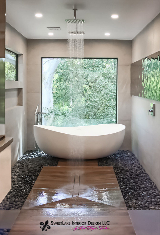 Inspiration for a large modern bathroom in Houston with flat-panel cabinets, a japanese tub, a shower/bathtub combo, a wall-mount toilet, beige tile, pebble tile floors, a vessel sink, quartzite benchtops, an open shower, grey benchtops, a niche, a double vanity and a floating vanity.