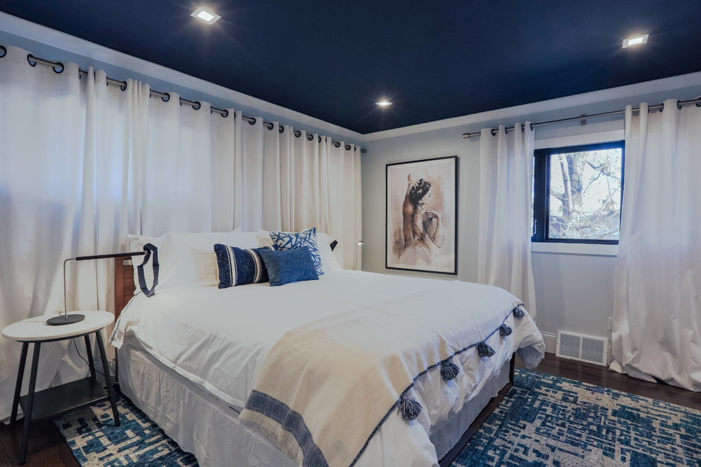 Inspiration for a small transitional master bedroom in Denver with blue walls, medium hardwood floors and brown floor.