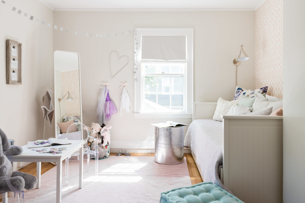 Inspiration for a transitional kids' playroom for girls in Boston with white walls, medium hardwood floors and brown floor.