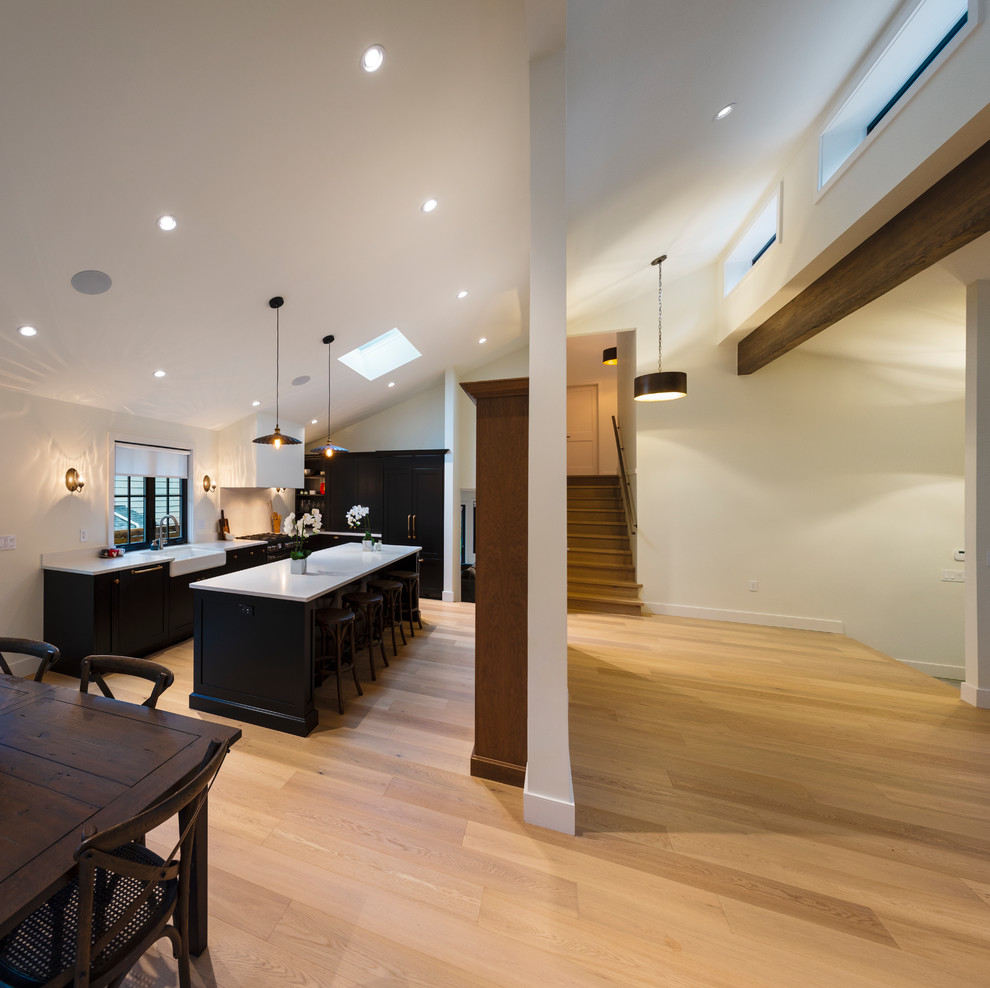 Example of a mid-sized mountain style light wood floor and beige floor hallway design in Vancouver with white walls