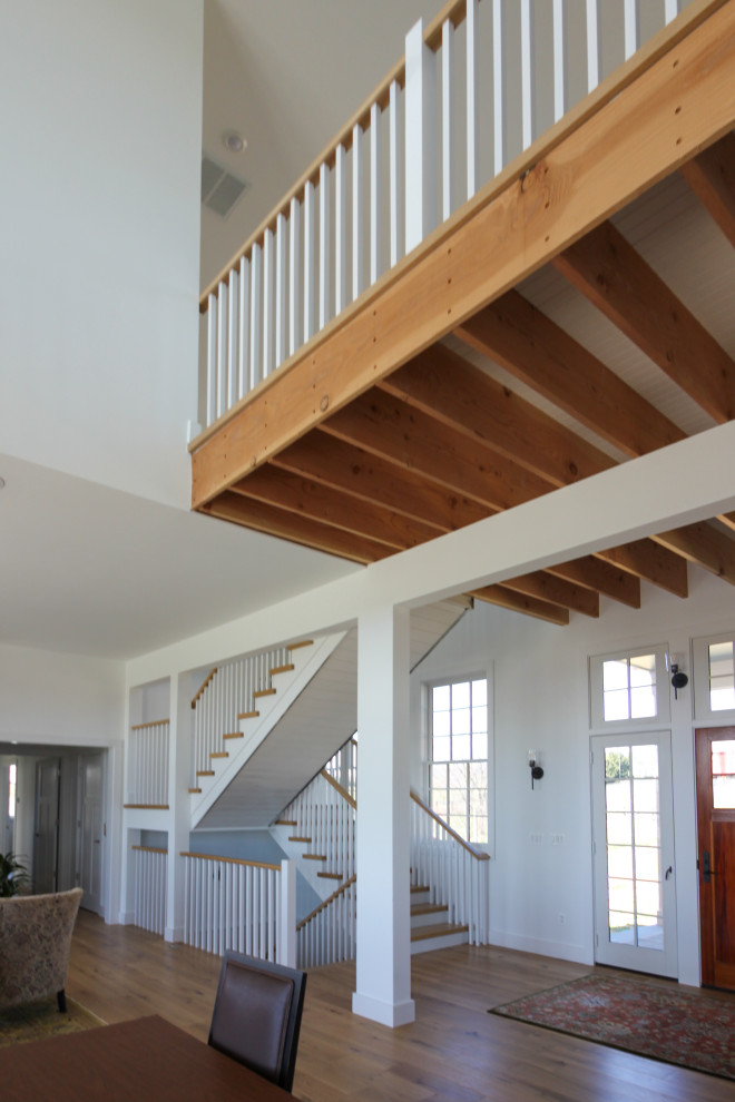 Imagen de escalera en U de estilo de casa de campo de tamaño medio con escalones de madera, contrahuellas de madera, barandilla de madera y machihembrado