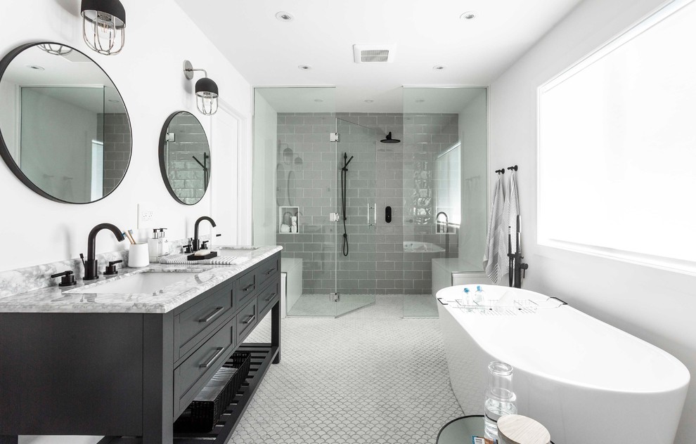 Design ideas for a large contemporary master bathroom in Montreal with furniture-like cabinets, grey cabinets, a freestanding tub, gray tile, white walls, mosaic tile floors, an undermount sink, marble benchtops, white floor, a hinged shower door, a curbless shower, a bidet, subway tile and white benchtops.