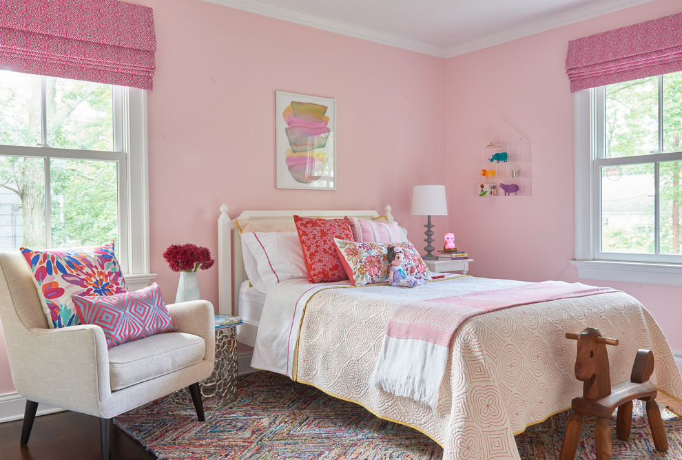 Transitional kids' bedroom in New York with pink walls, carpet and multi-coloured floor for girls.