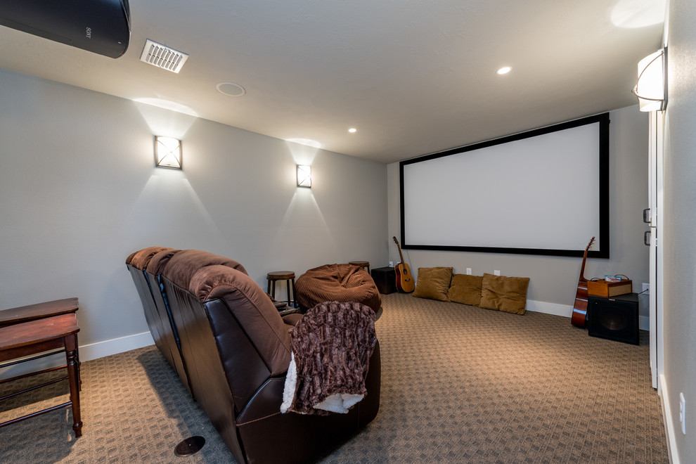 This is an example of a mid-sized arts and crafts enclosed home theatre in Other with grey walls, carpet, a projector screen and grey floor.