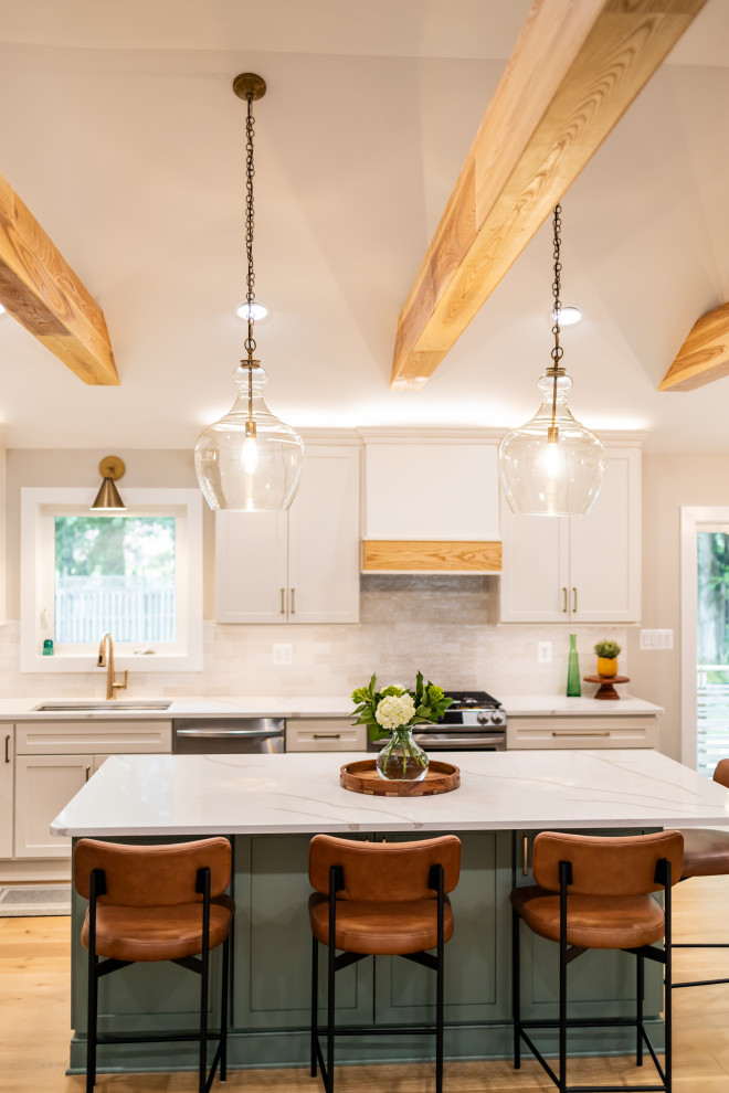 Example of a large transitional l-shaped light wood floor, brown floor and exposed beam eat-in kitchen design in DC Metro with an undermount sink, shaker cabinets, quartz countertops, white backsplash, porcelain backsplash, stainless steel appliances, an island and white countertops