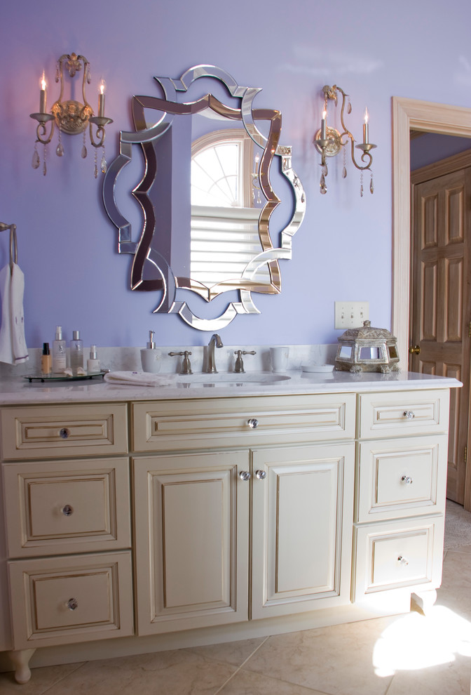 This is an example of a mid-sized traditional master bathroom in Other with an undermount sink, raised-panel cabinets, white cabinets, engineered quartz benchtops, a drop-in tub, an alcove shower, a two-piece toilet, beige tile, purple walls and ceramic floors.