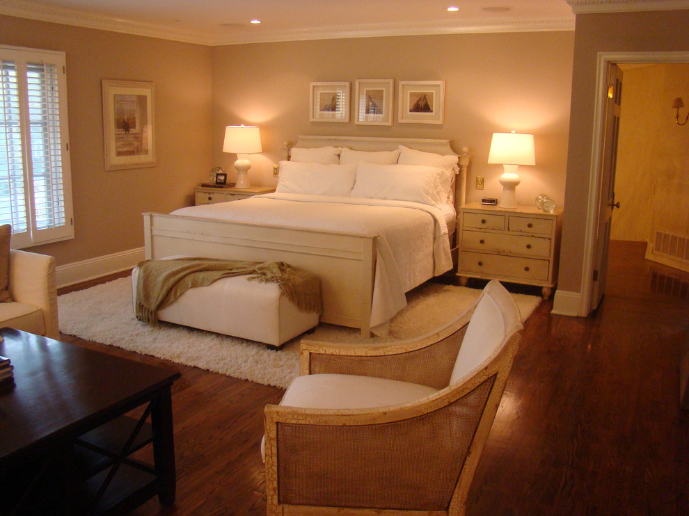 Photo of a traditional master bedroom in Los Angeles with beige walls and medium hardwood floors.