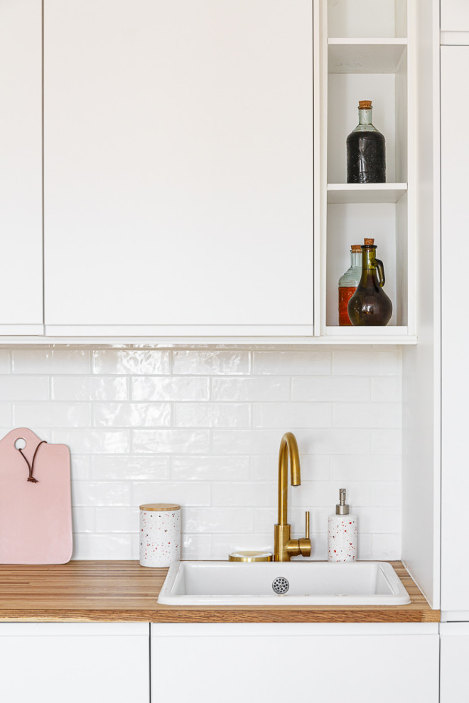 Design ideas for a small single-wall open plan kitchen in Paris with a drop-in sink, beaded inset cabinets, white cabinets, wood benchtops, white splashback, terra-cotta splashback, panelled appliances, ceramic floors, no island, grey floor and beige benchtop.