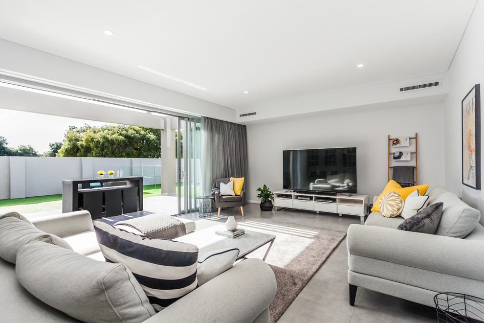 Contemporary open concept family room in Perth with white walls.