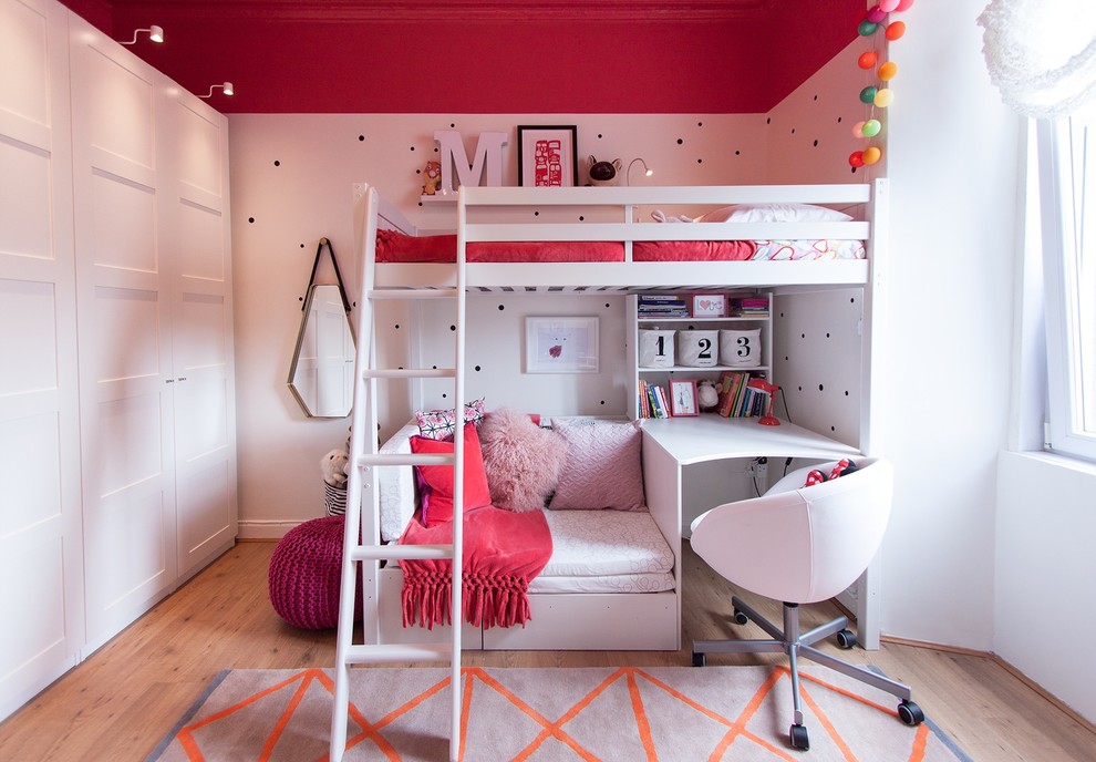 Photo of a mid-sized contemporary kids' bedroom for kids 4-10 years old and girls in Edinburgh with multi-coloured walls and light hardwood floors.