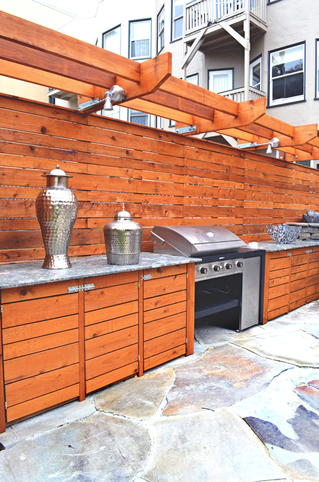 Photo of a contemporary patio in San Francisco with natural stone pavers and no cover.