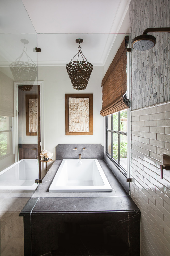 Inspiration for a transitional master bathroom in Houston with a drop-in tub, a corner shower, gray tile, white tile and subway tile.