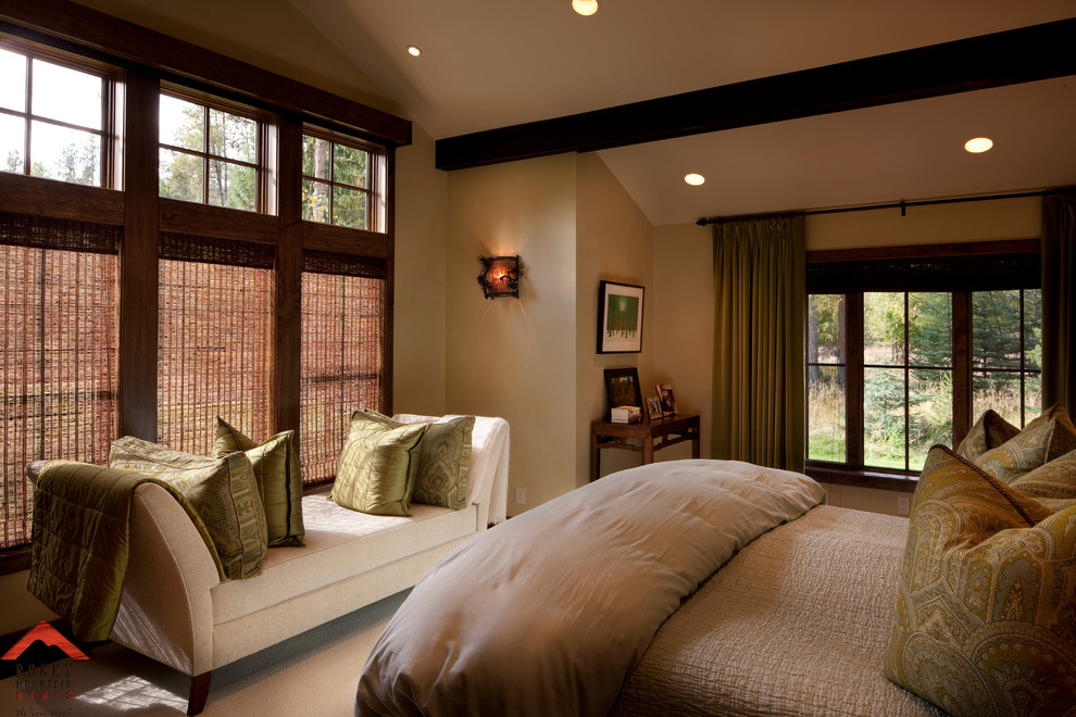 Photo of a mid-sized country guest bedroom in Other with beige walls and carpet.