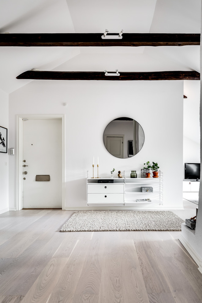 Design ideas for a mid-sized scandinavian entryway in Stockholm with white walls and grey floor.