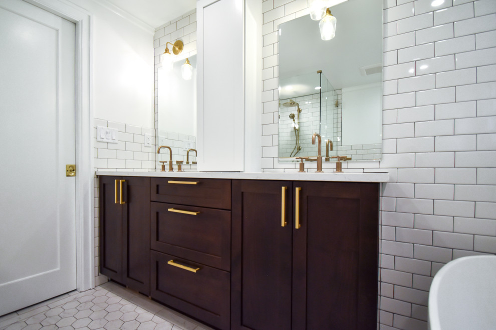 Photo of a mid-sized traditional master bathroom in Portland with recessed-panel cabinets, dark wood cabinets, a freestanding tub, an alcove shower, a two-piece toilet, white tile, ceramic tile, white walls, ceramic floors, an undermount sink, engineered quartz benchtops, grey floor, a hinged shower door, white benchtops, a niche, a double vanity and a built-in vanity.