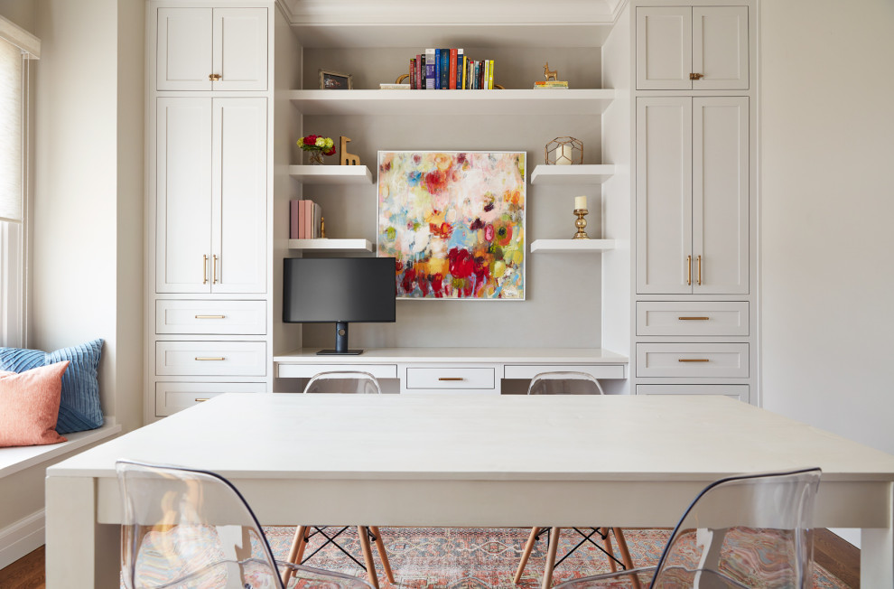 This is an example of a large classic craft room in Other with a built-in desk.