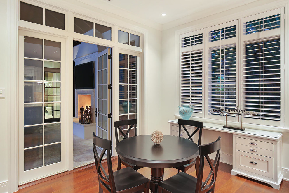 Inspiration for a large tropical kitchen/dining combo in Tampa with white walls and medium hardwood floors.