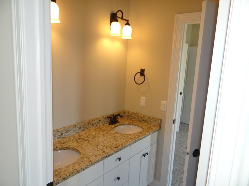 Bathroom - small transitional master bathroom idea with shaker cabinets, white cabinets, beige walls, an undermount sink and granite countertops