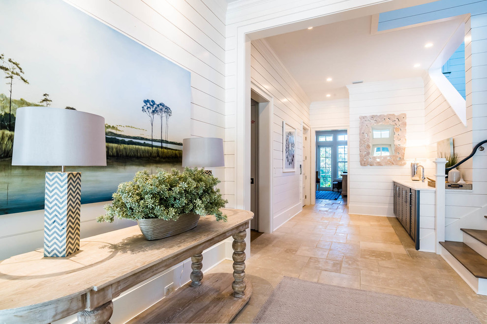 This is an example of an expansive beach style foyer in Other with white walls, a single front door, a blue front door and beige floor.