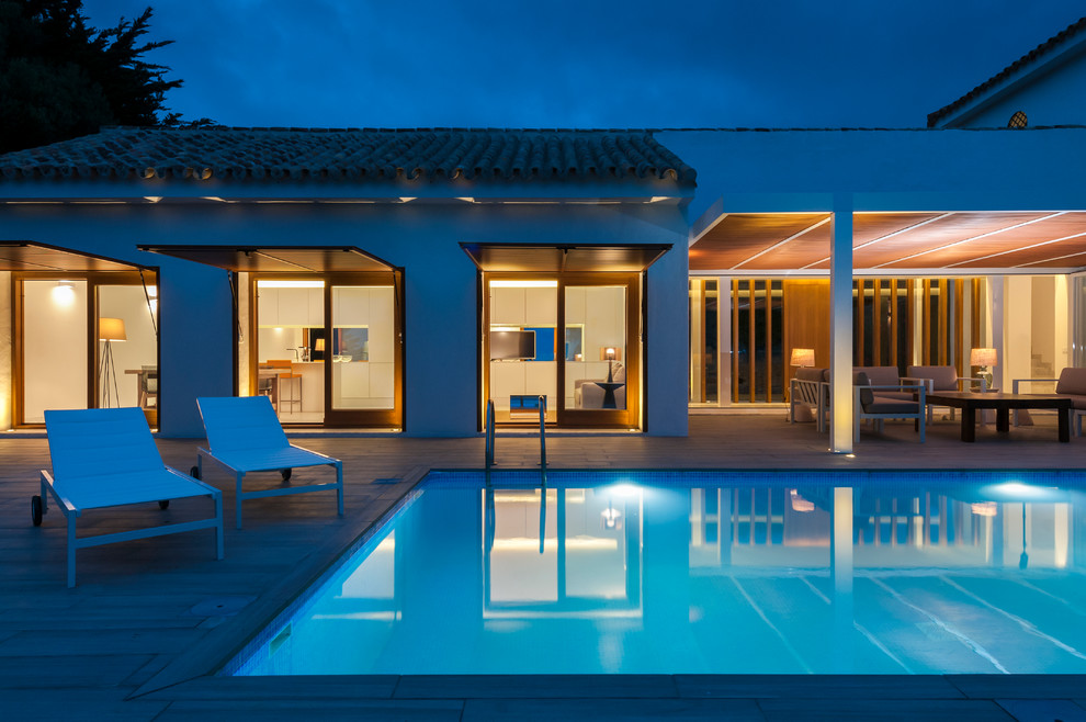 Inspiration for a mid-sized mediterranean rectangular lap pool in Seville with a pool house.