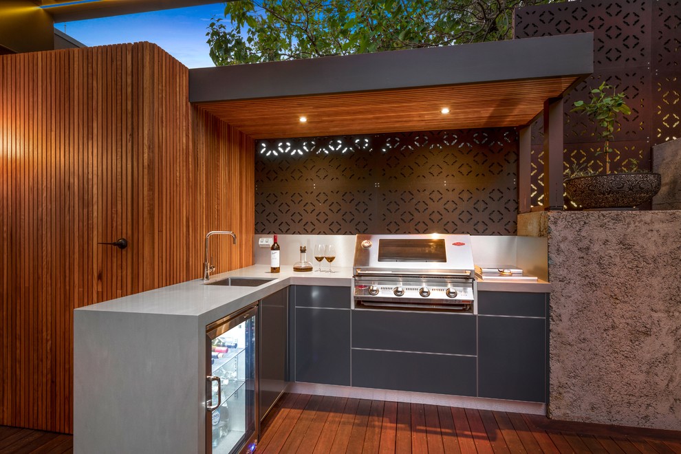 Design ideas for a mid-sized contemporary backyard deck in Melbourne with an outdoor kitchen and a pergola.