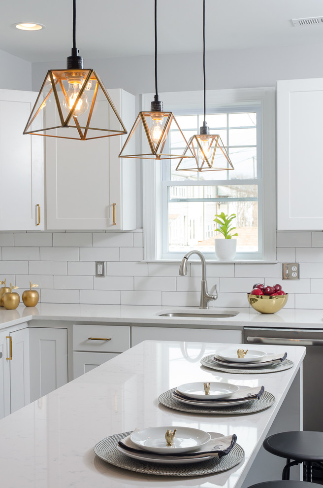 Design ideas for a transitional kitchen in DC Metro with an undermount sink, shaker cabinets, white cabinets, white splashback, subway tile splashback, stainless steel appliances and with island.