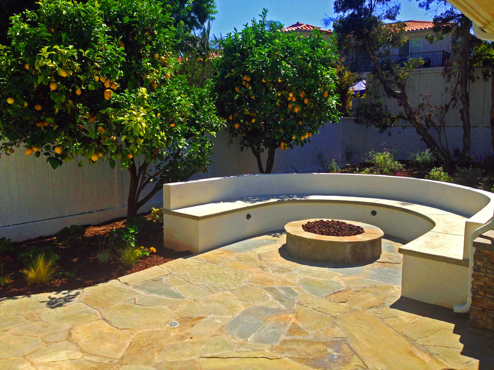 Photo of a mid-sized transitional backyard patio in Orange County with a fire feature, concrete slab and no cover.