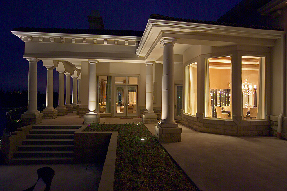 Photo of an expansive mediterranean two-storey stucco beige exterior in Omaha.