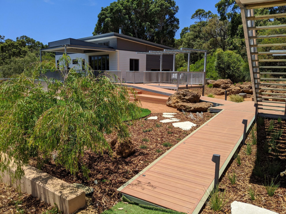 Photo of an expansive beach style backyard deck in Perth with a pergola.