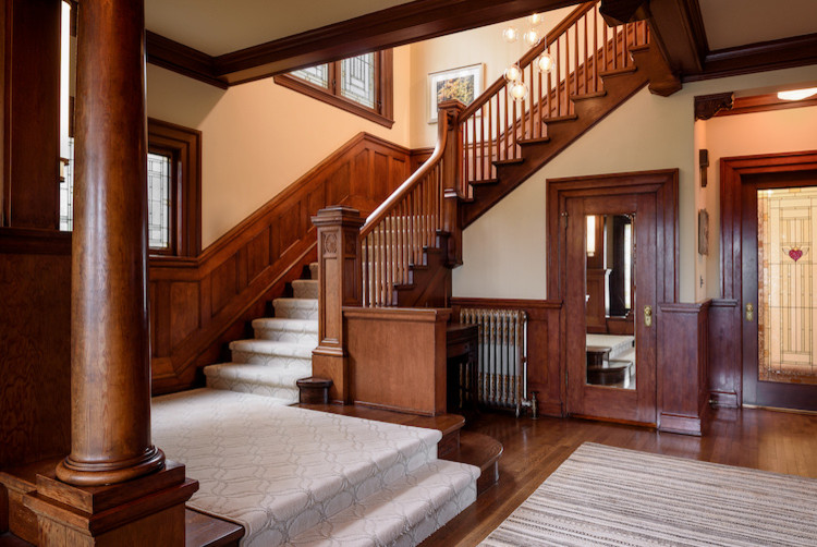 Inspiration for a mid-sized arts and crafts carpeted l-shaped staircase in Seattle with carpet risers and wood railing.