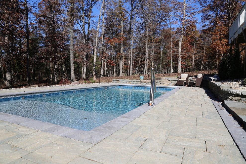 Large mountain style backyard concrete paver and rectangular pool photo in DC Metro
