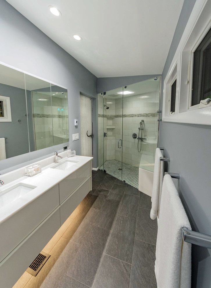 Modern bathroom in Atlanta with a curbless shower, grey walls, grey floor and white benchtops.