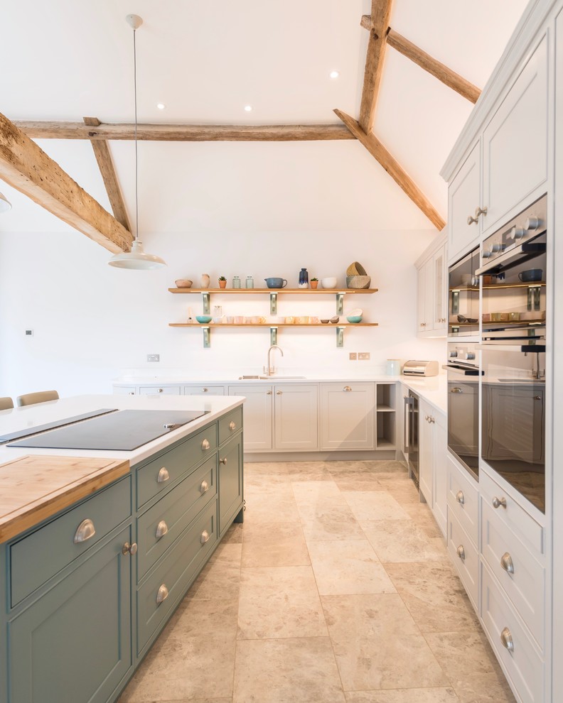 Design ideas for a large beach style l-shaped eat-in kitchen in Dorset with an undermount sink, shaker cabinets, blue cabinets, quartzite benchtops, panelled appliances, limestone floors, with island and yellow benchtop.