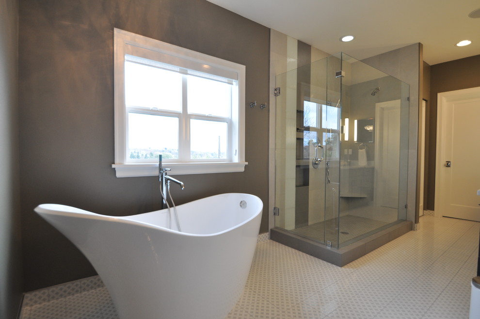 This is an example of a large transitional master bathroom in Seattle with a freestanding tub, an open shower, grey walls, gray tile, porcelain tile, mosaic tile floors, multi-coloured floor, a hinged shower door, shaker cabinets, dark wood cabinets, a two-piece toilet, an undermount sink and marble benchtops.