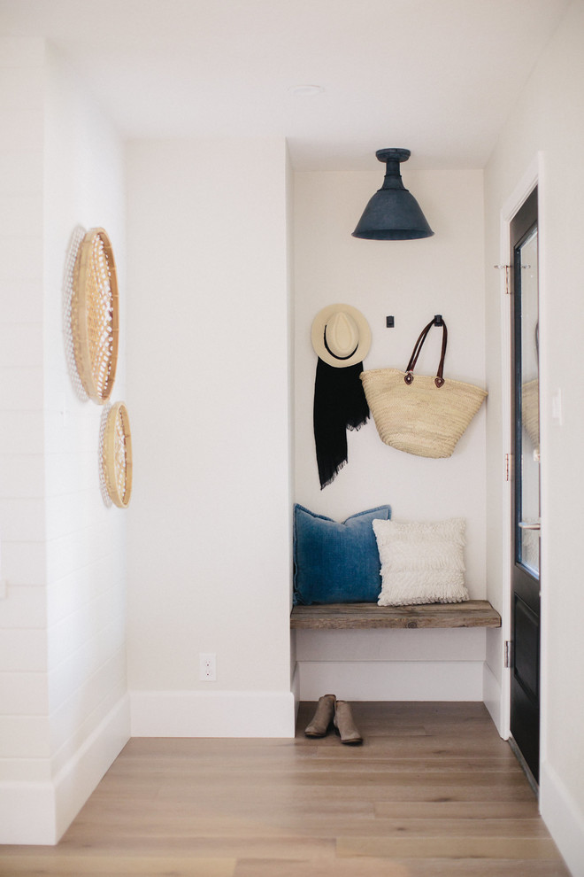 Small transitional foyer photo with gray walls and a black front door