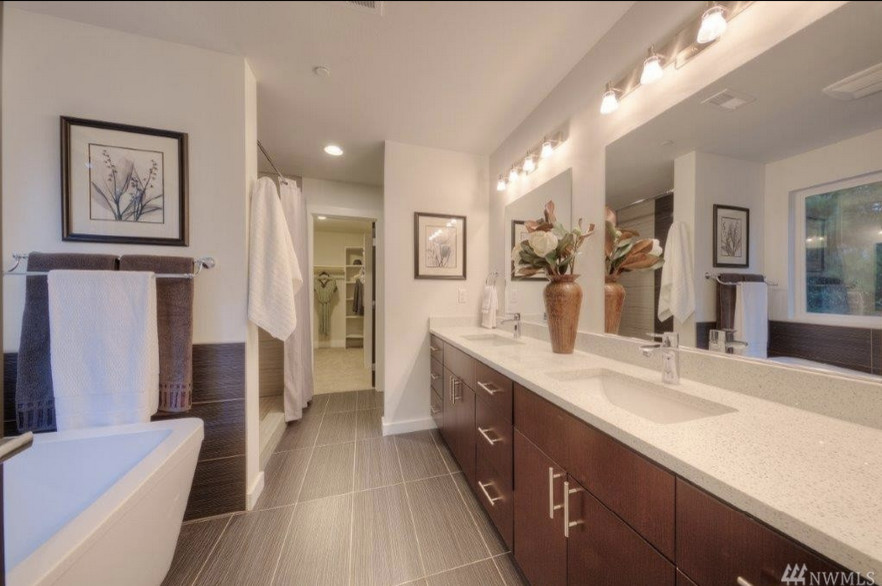 Design ideas for a large contemporary master bathroom in Seattle with an undermount sink, flat-panel cabinets, medium wood cabinets, engineered quartz benchtops, an alcove tub, a shower/bathtub combo, a one-piece toilet, white walls and porcelain floors.