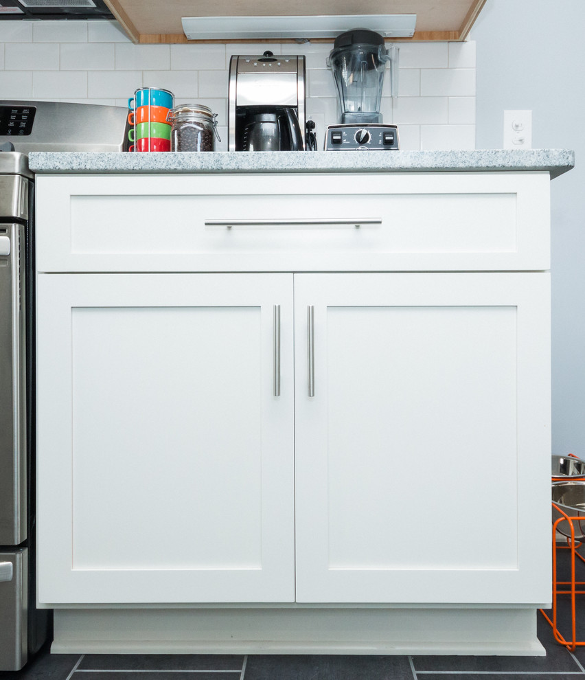 Inspiration for a mid-sized transitional l-shaped eat-in kitchen remodel in Columbus with an undermount sink, shaker cabinets, white cabinets, granite countertops, white backsplash, subway tile backsplash and stainless steel appliances