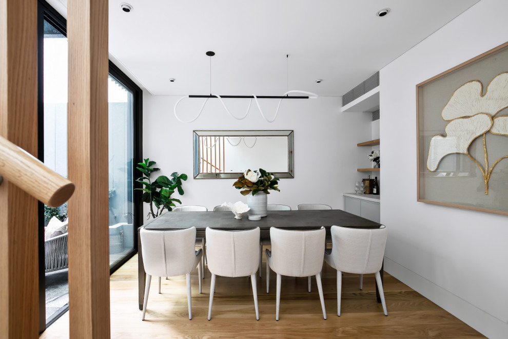 This is an example of a contemporary dining room in Sydney.