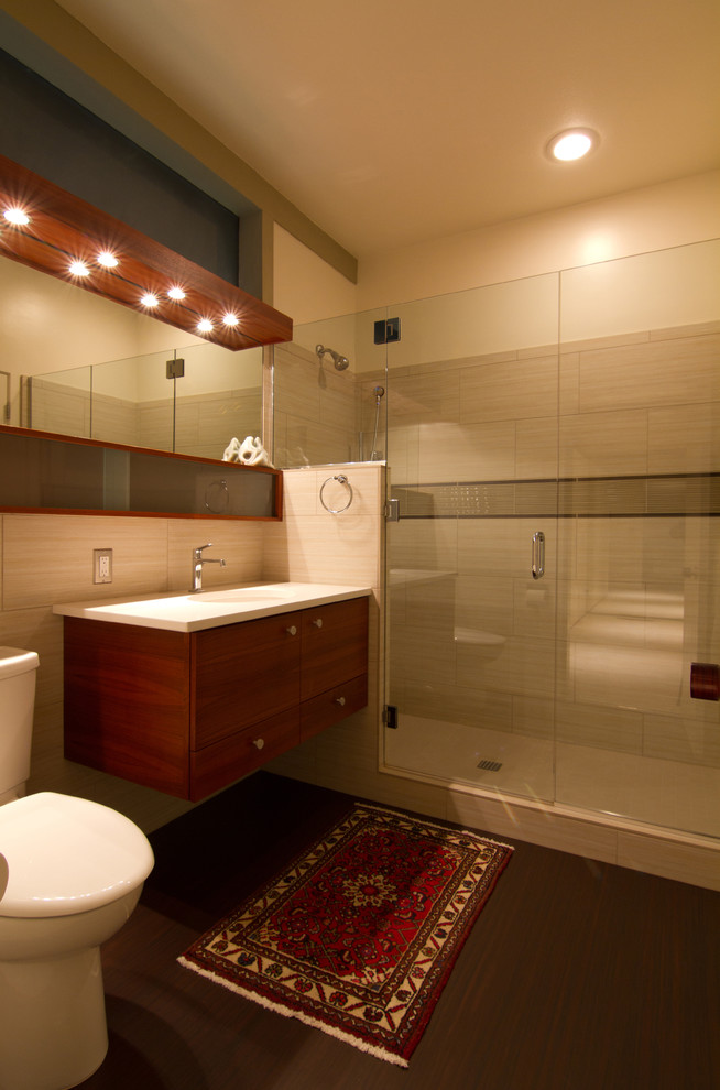 Contemporary bathroom in Portland with flat-panel cabinets, dark wood cabinets, an alcove shower, a two-piece toilet and beige tile.