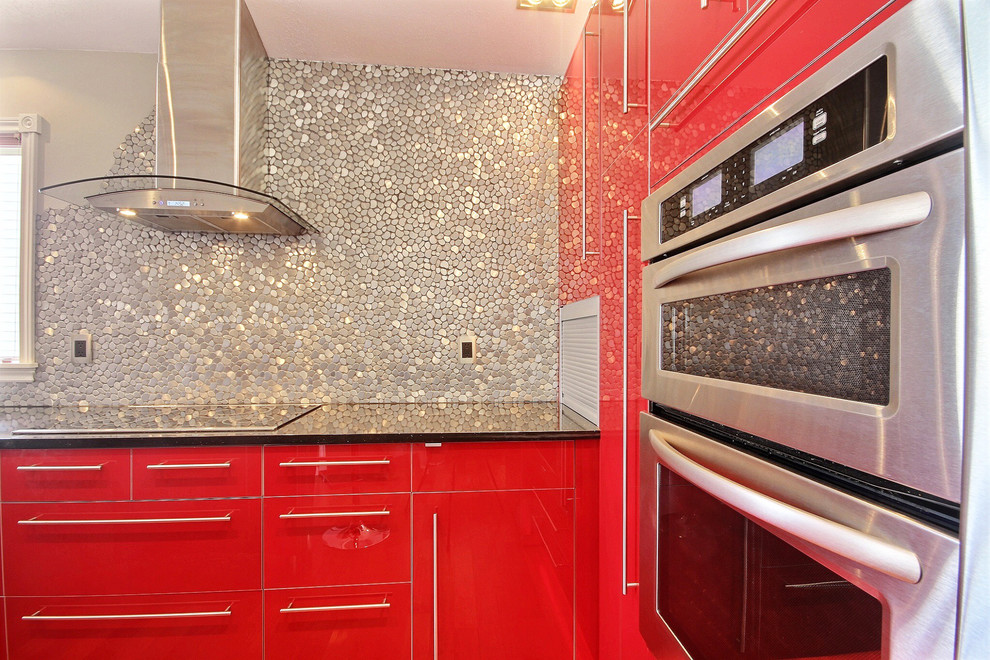 Contemporary eat-in kitchen in Miami with metal splashback.