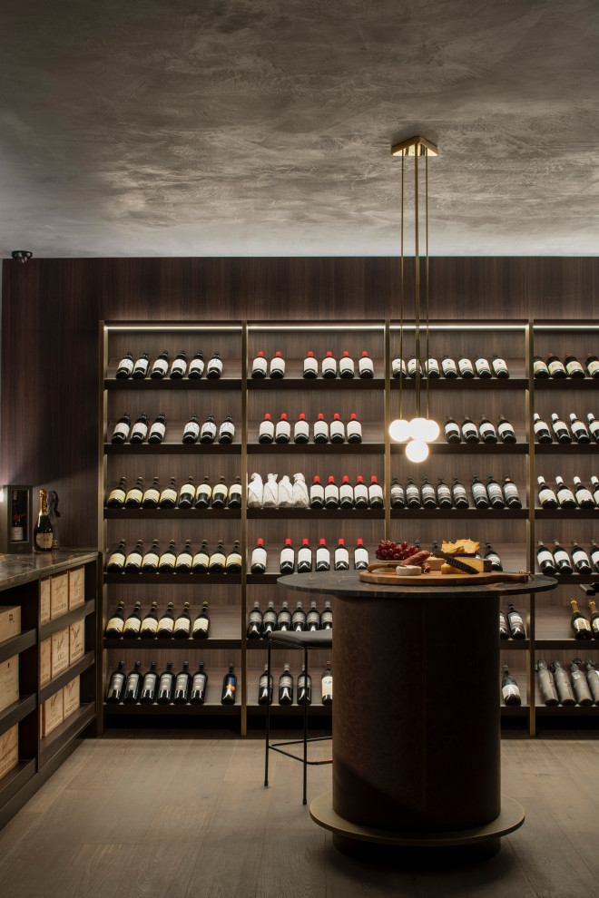 Wine cellar - mid-sized contemporary medium tone wood floor and gray floor wine cellar idea in Sydney with storage racks