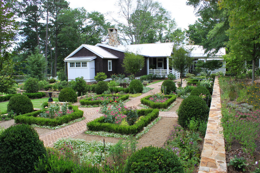 Photo of a large country backyard formal garden in Atlanta with brick pavers.