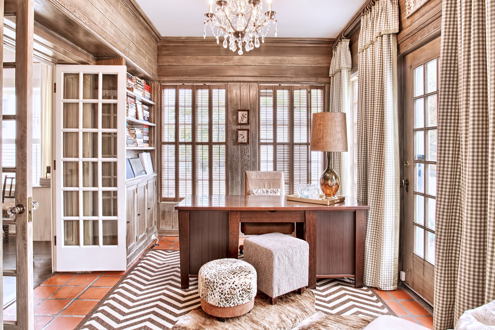 Traditional home office in Chicago with terra-cotta floors and a freestanding desk.