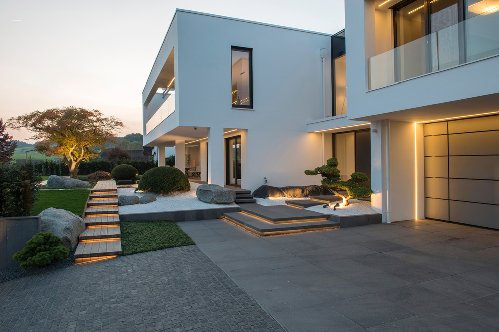 Large contemporary two-storey stucco white house exterior in Other with a flat roof.