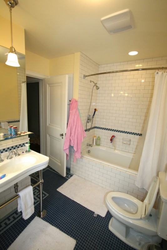 Inspiration for a mid-sized country master bathroom in Bridgeport with a console sink, a drop-in tub, a shower/bathtub combo, a two-piece toilet, multi-coloured tile, subway tile, yellow walls and ceramic floors.