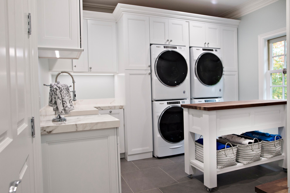 Design ideas for an expansive traditional l-shaped laundry room in Detroit with an undermount sink, beaded inset cabinets, white cabinets, quartz benchtops, multi-coloured splashback, ceramic splashback, dark hardwood floors, brown floor and white benchtop.