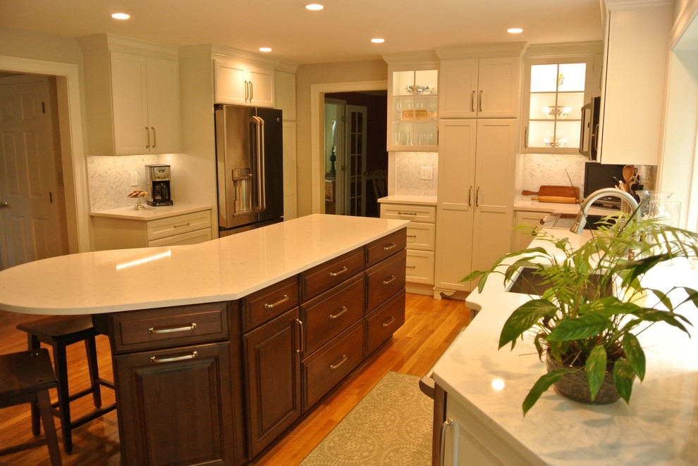 Example of a transitional medium tone wood floor eat-in kitchen design in Boston with an undermount sink, shaker cabinets, quartz countertops, beige backsplash, mosaic tile backsplash, stainless steel appliances, an island and white countertops